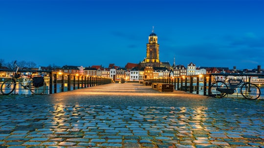 city with high-rise buildings viewing body of water during night time in Deventer Netherlands