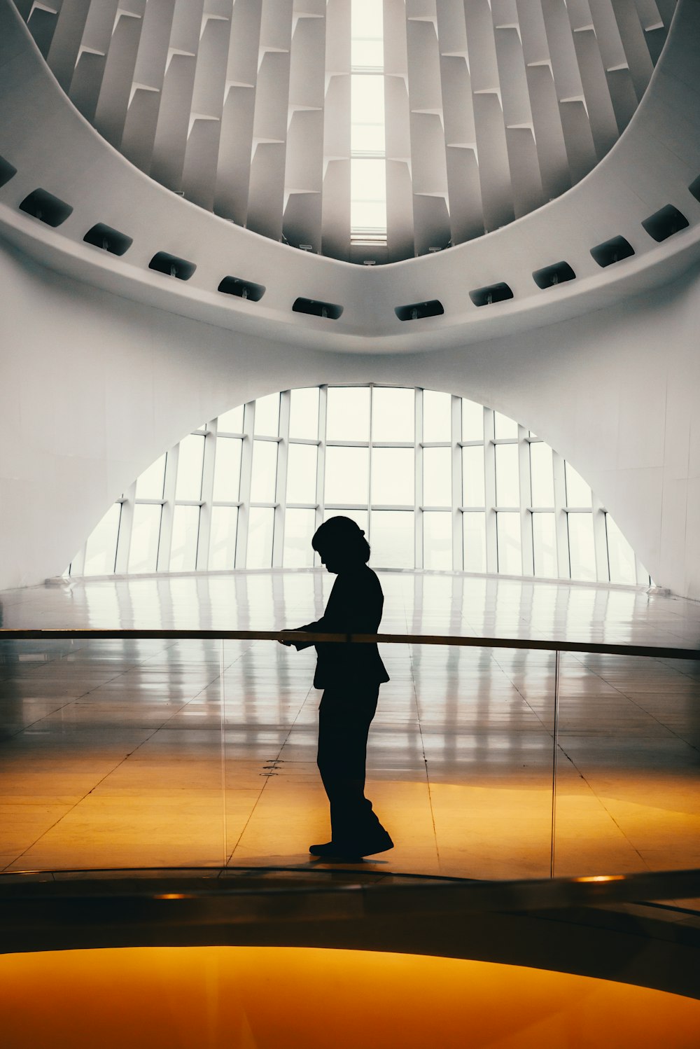 person standing and holding on railings