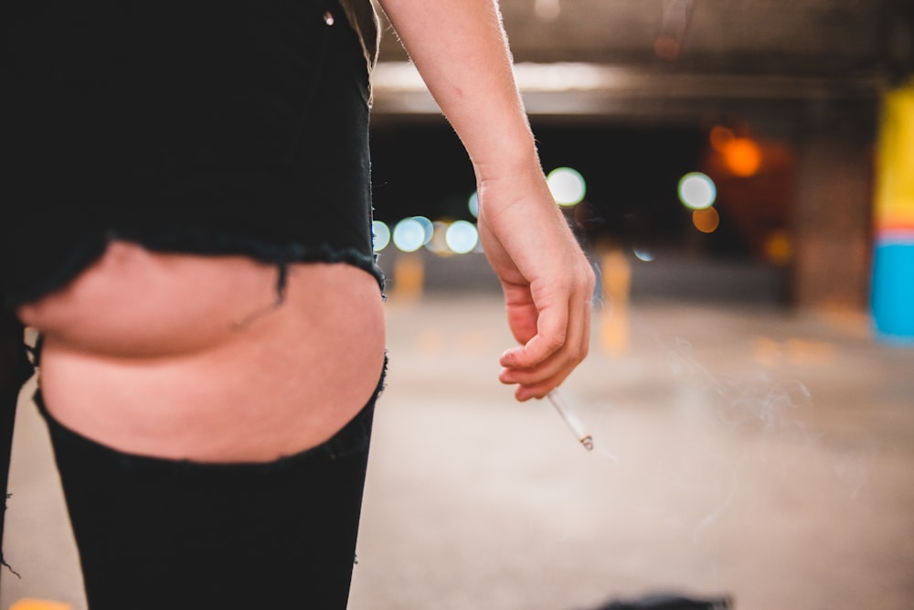 woman in black shorts inside a lighted parking lot