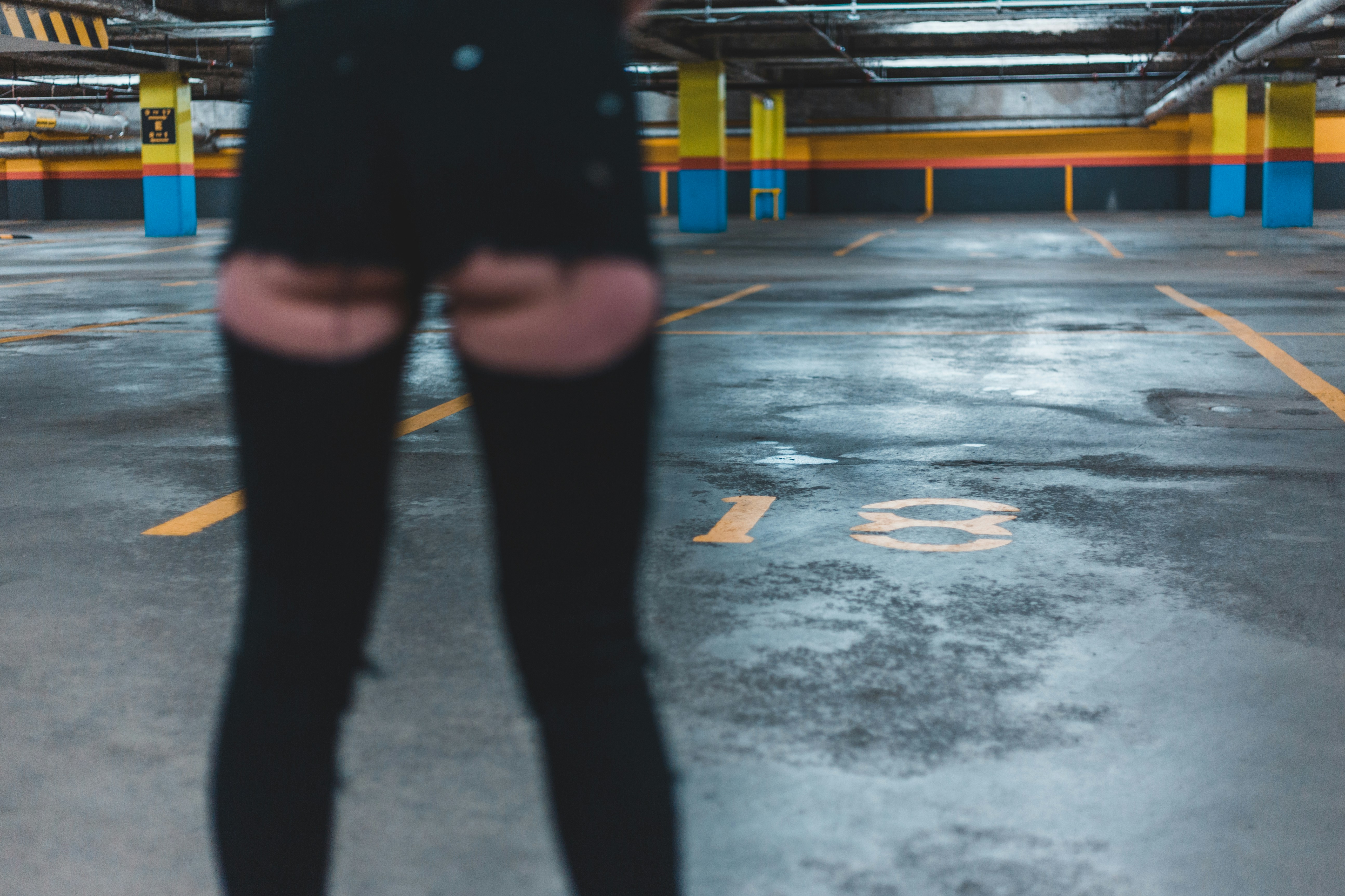 woman in black short shorts and thigh-high boots at parking lot