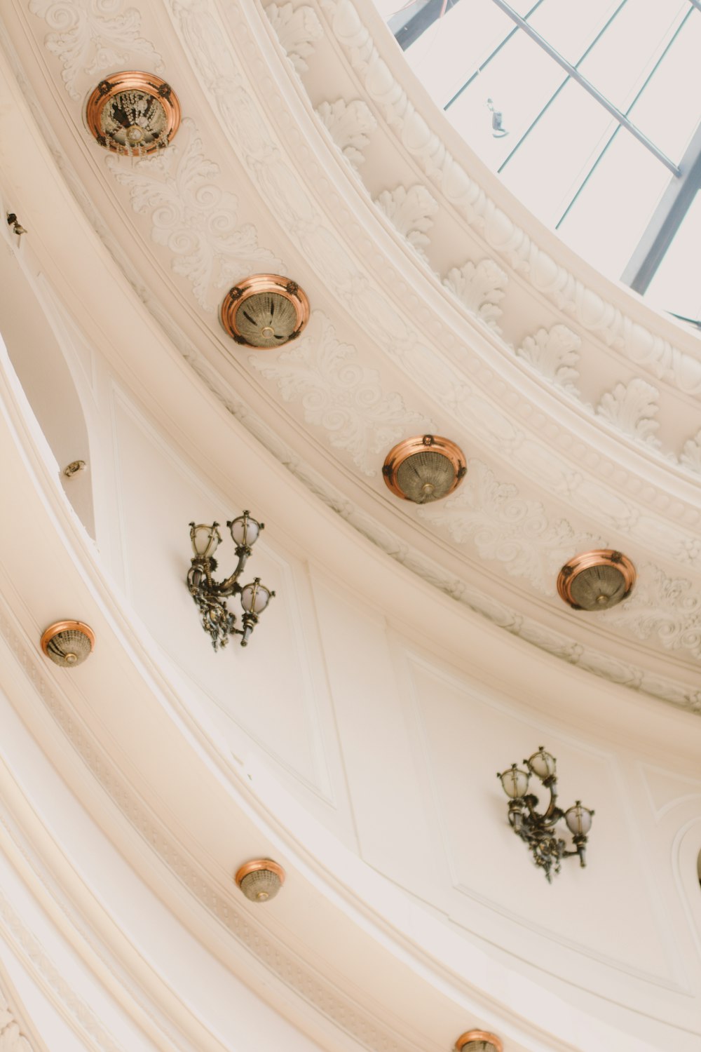 the ceiling of a church with a clock on it