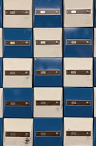 Close-up of a mailbox rental area with secure, numbered mailboxes in blue and white.