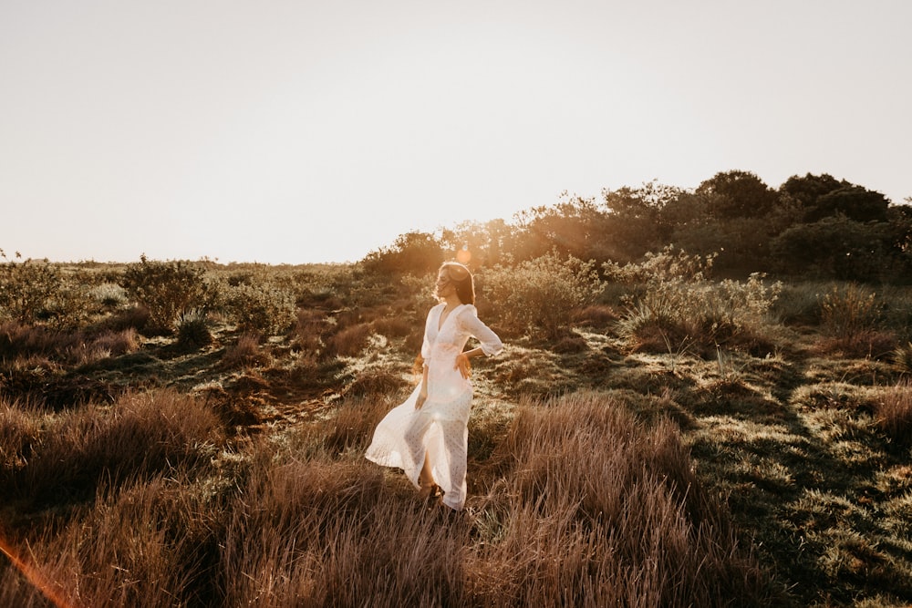 woman in white dress on slope during daytime