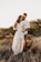 shallow focus photo of man hugging woman in white long-sleeved dress