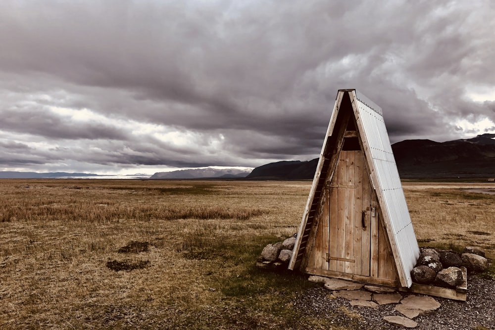 brown wooden shed under cloudy sky during daytime