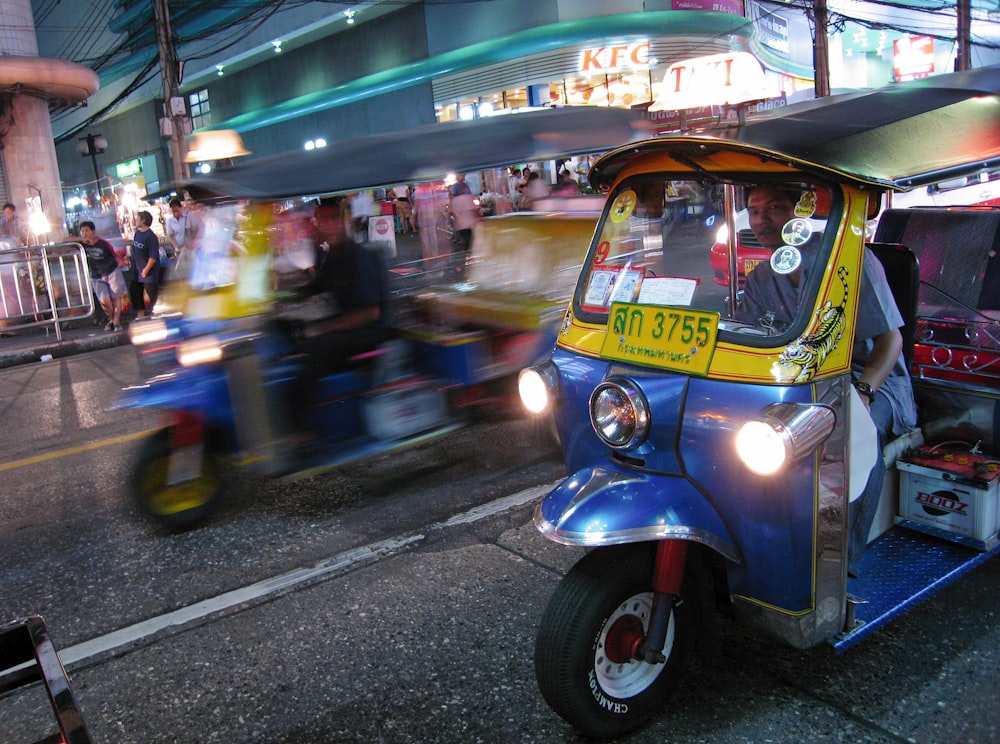man riding on auto rickshaw
