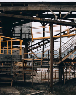 Completed steel structure with yellow safety railings and industrial equipment around