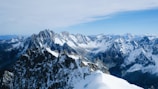 A panoramic view of the snow-capped mountains surrounding Ushuaia under a clear blue sky.