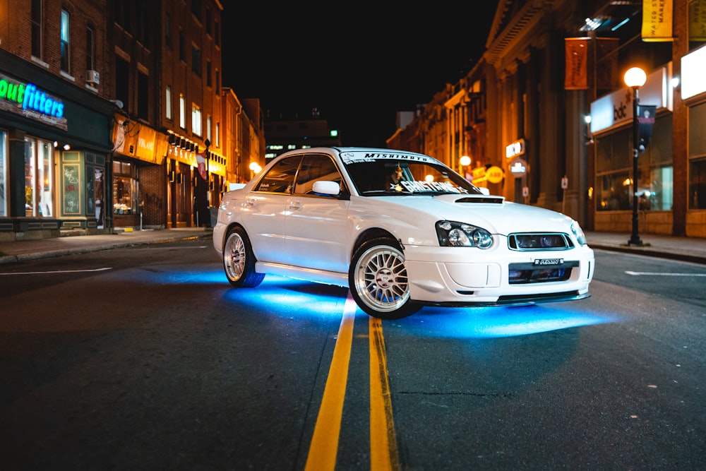 white SUbaru Impreza sedan on road