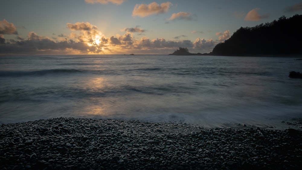 body of water and sunrise