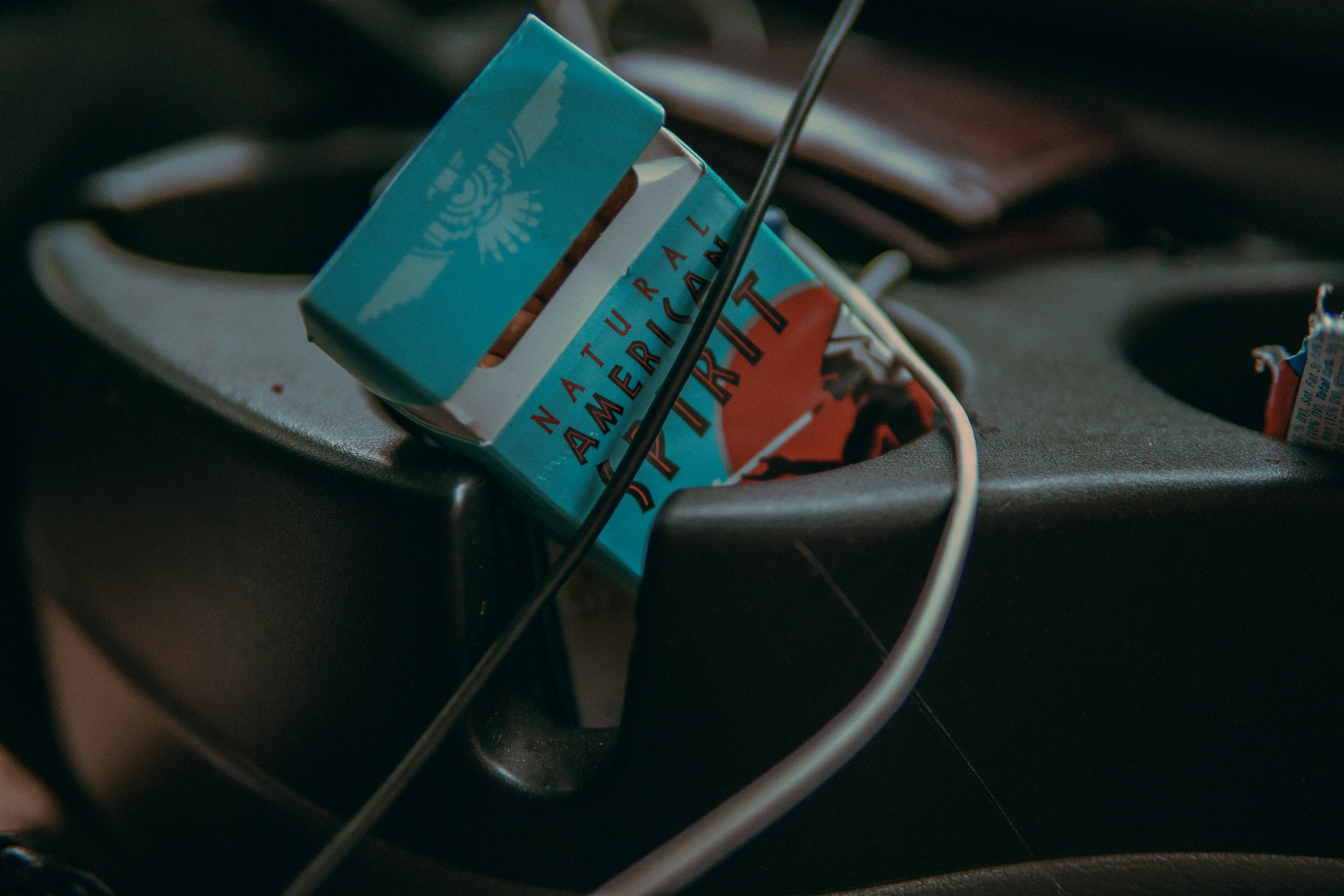 Spirit cigarette pack on black armrest