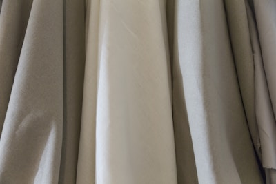 An instructor demonstrating fabric draping techniques to a small group.