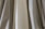 A close-up of various pleated fabric samples displayed on a table.