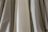 A close-up of various pleated fabric samples displayed on a table.