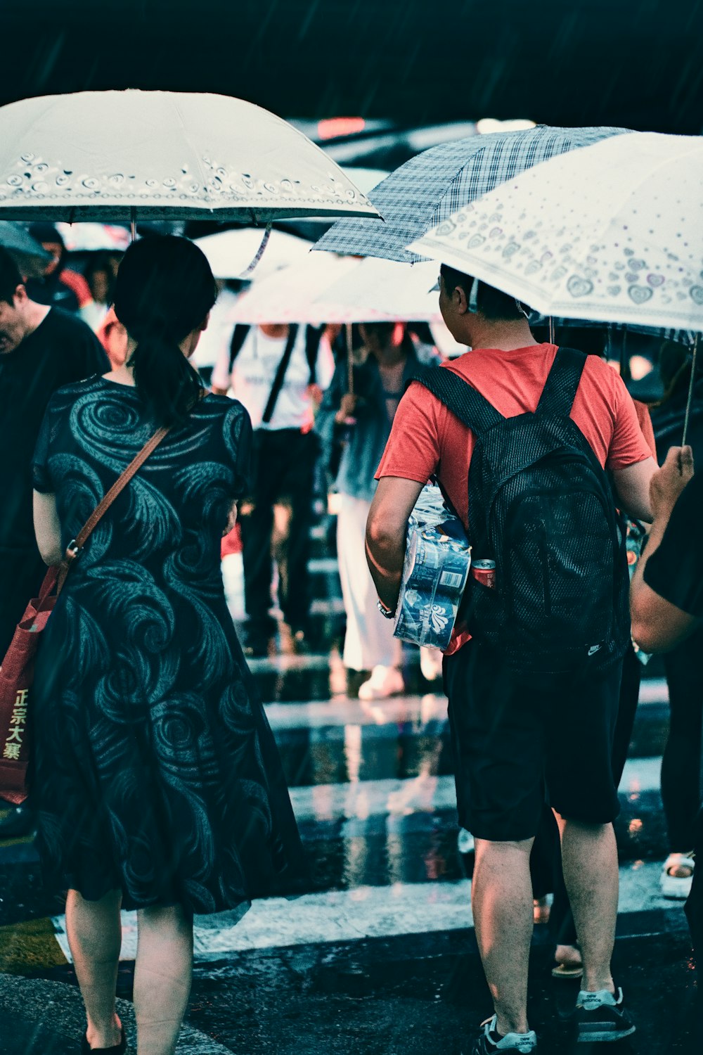 man wearing black backpack holding white umbrella