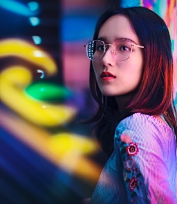 woman standing near neon sign