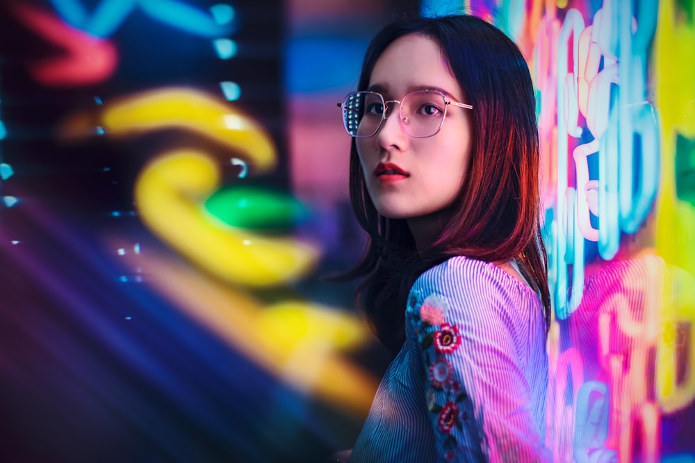 woman standing near neon sign