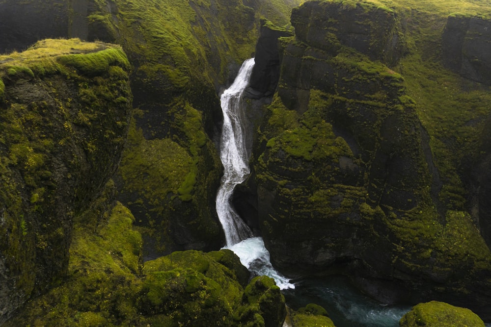 waterfall and rocky cliff with moss