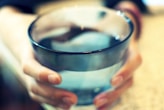 hands around a glass of water 