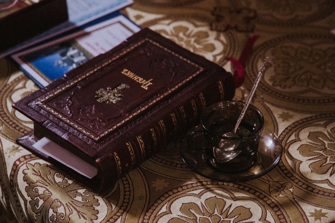 photo of beige and maroon bible
