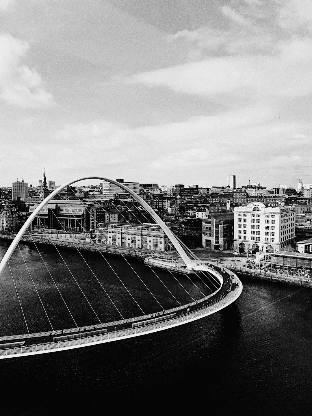 grayscale photography of bridge near city