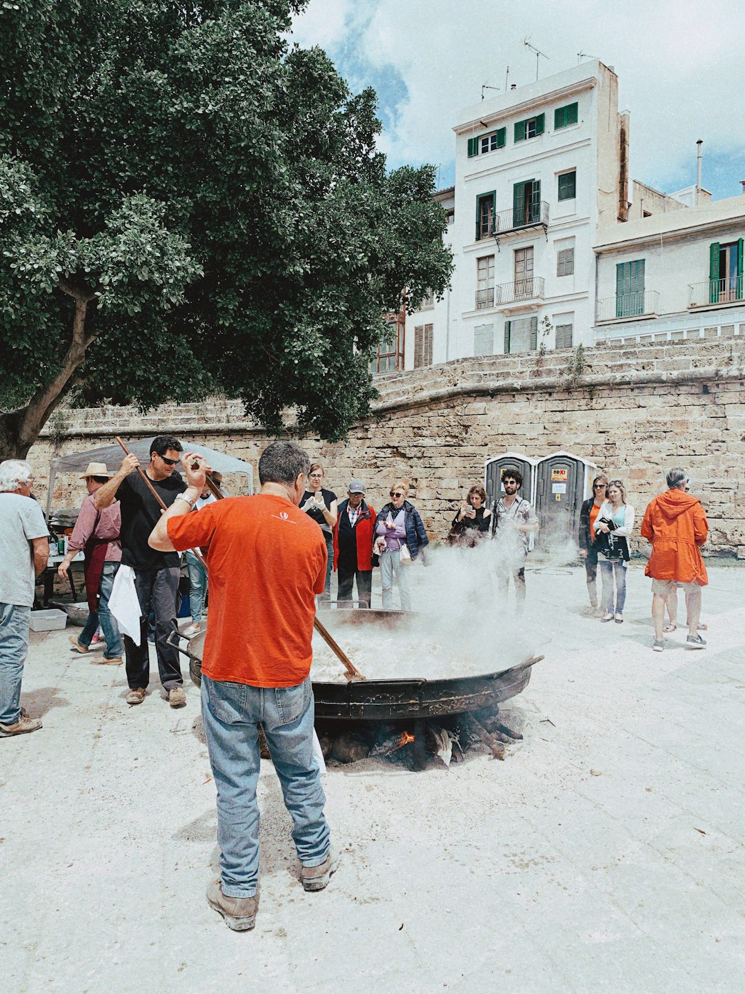 people standing near cook pot