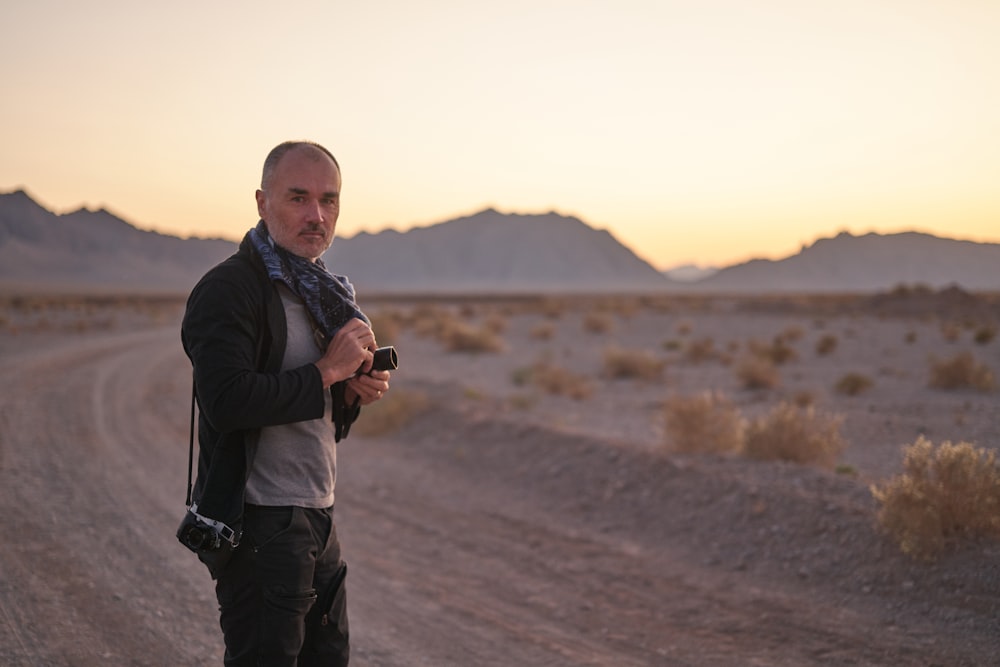 man holding black DSLR camera