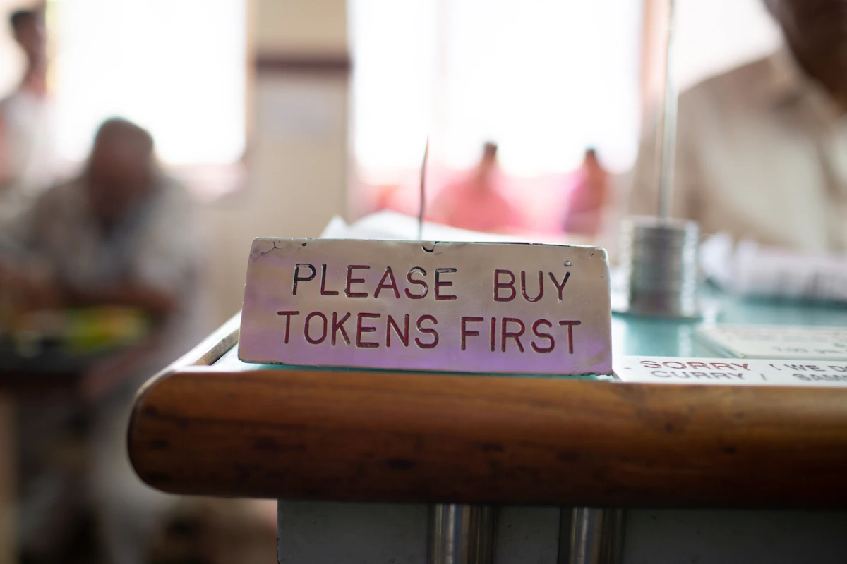 A sign at a thali restaurant asking diners to buy tokens first