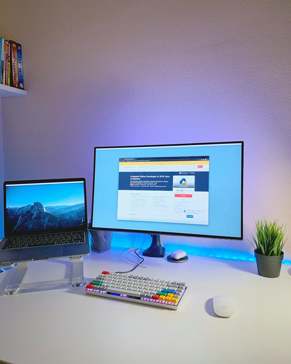 flat screen monitor and laptop on desk