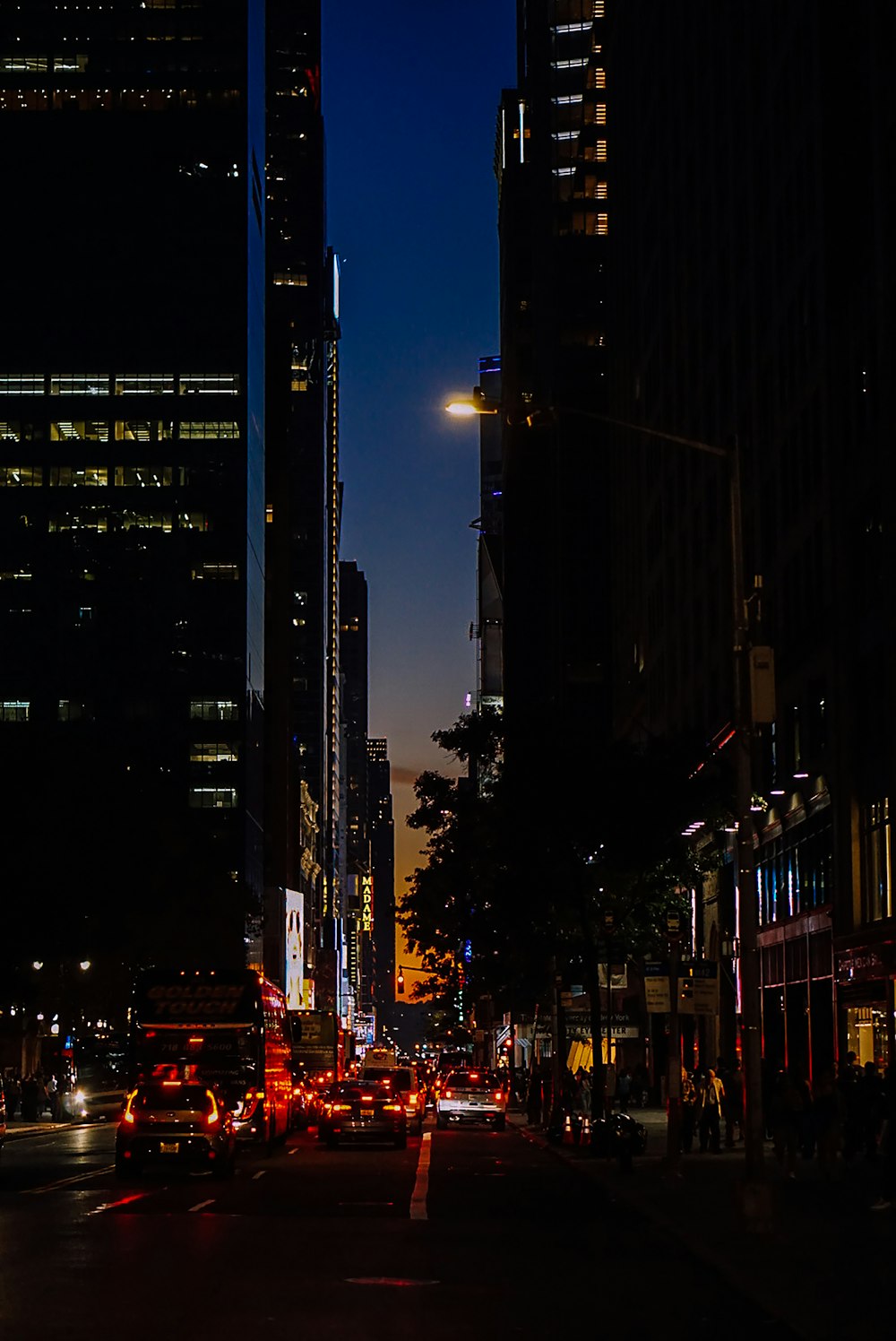 a city street filled with lots of traffic at night