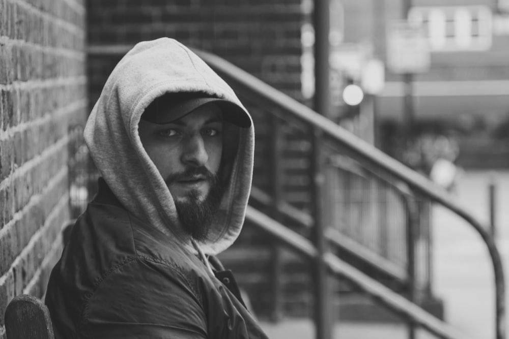 grayscale photography of man wearing hoodie