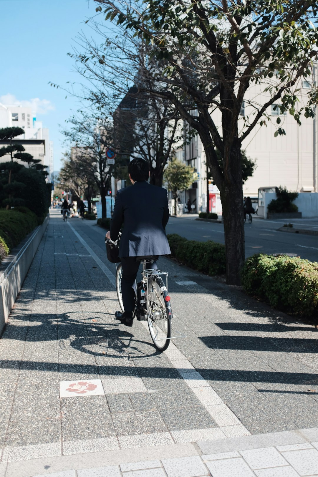 man wearing blazer riding on bike