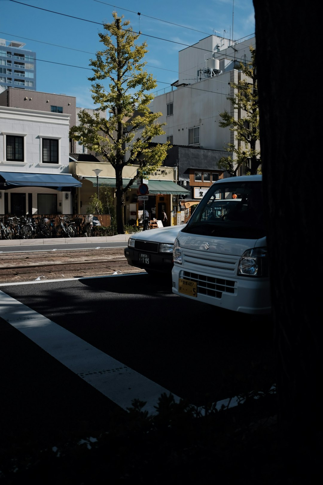 white vehicle parked beside another vehicle