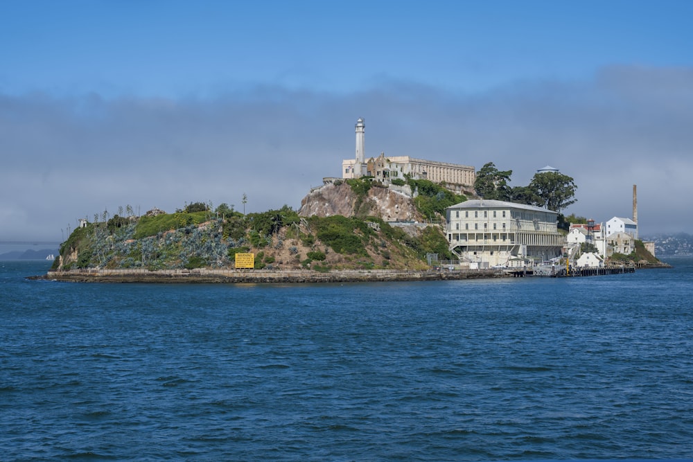 white concrete buildings and green island