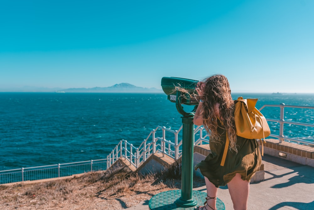 woman looking at telescope