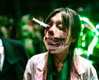 a woman with blood on her face and a cigarette in her mouth