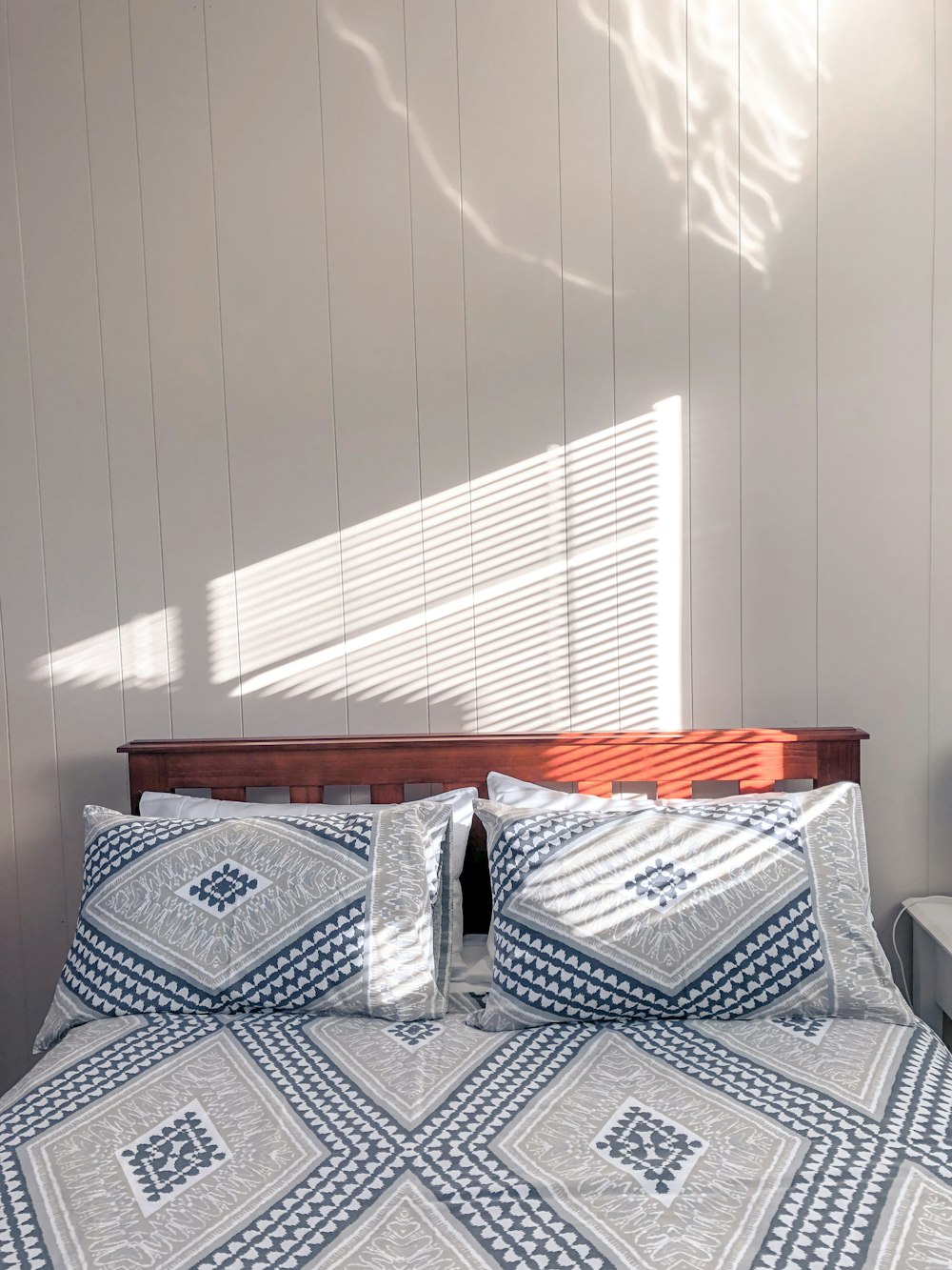 gray and black pillows on bed