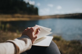 A serene outdoor scene with someone journaling, reflecting balance between work and life.