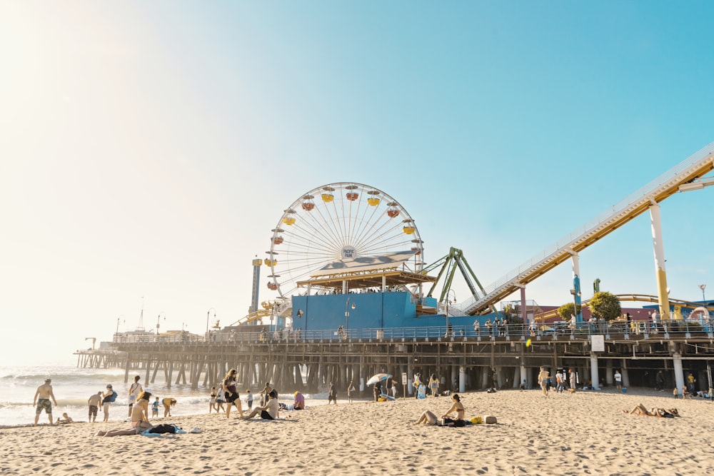 photo of yellow and white Ferris Wheel and seashore