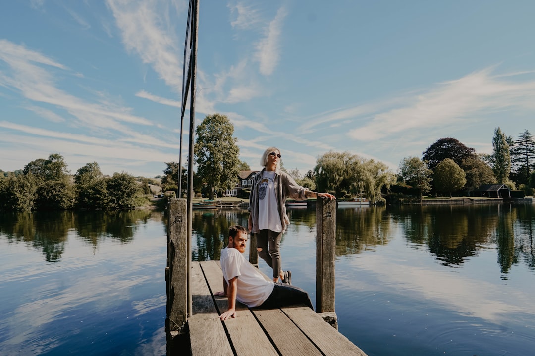 man and woman on wooden dock