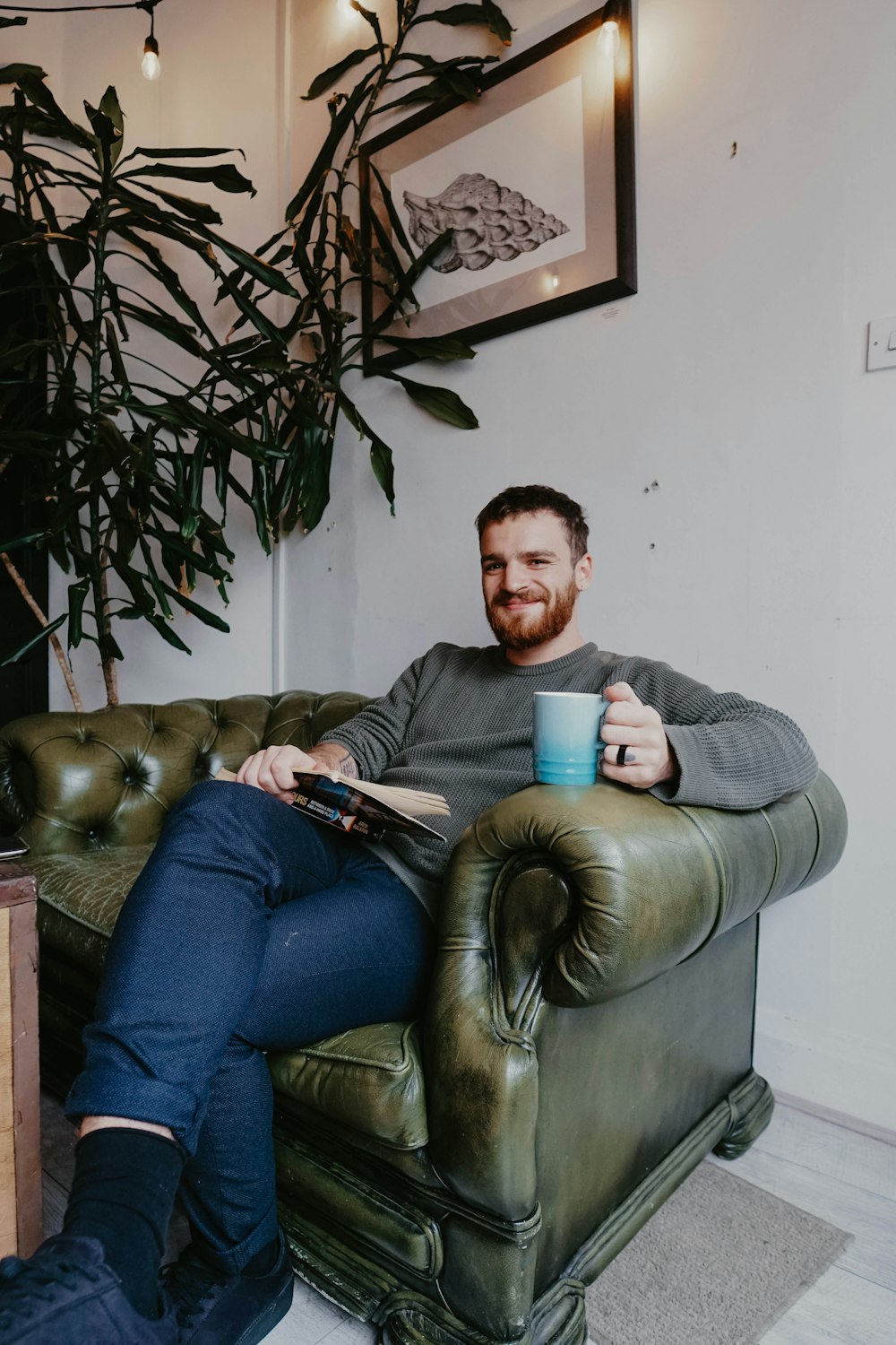 man sitting on brown leather sofa