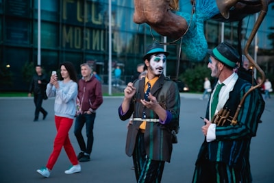 Street performers in medieval costumes engaging with crowds during a festival.