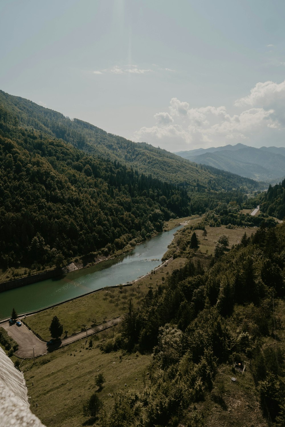 river beside mountain during daytime