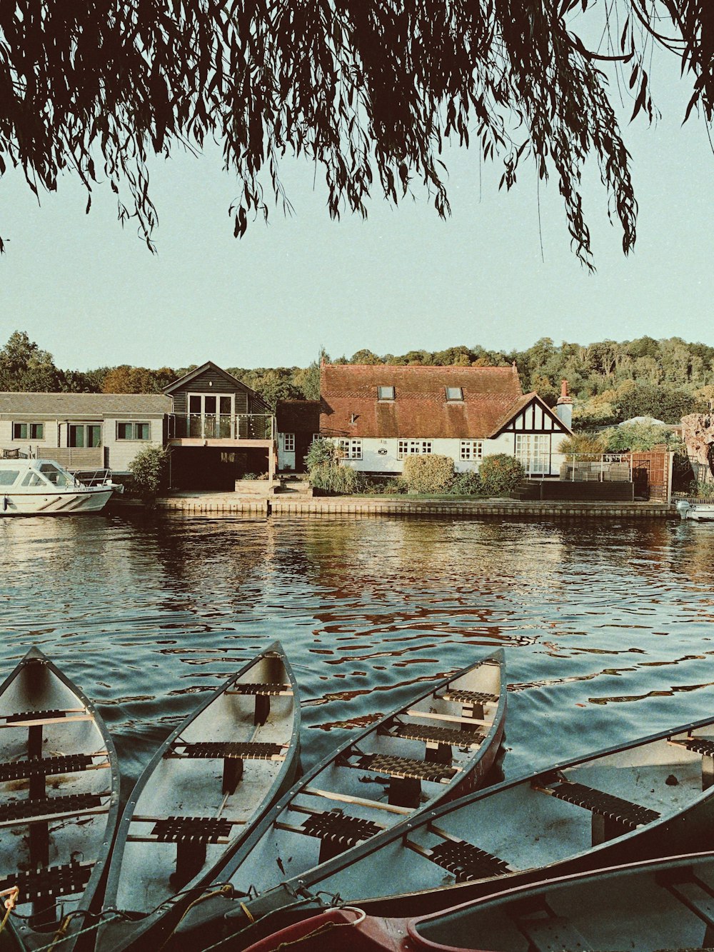 four gray canoes on river