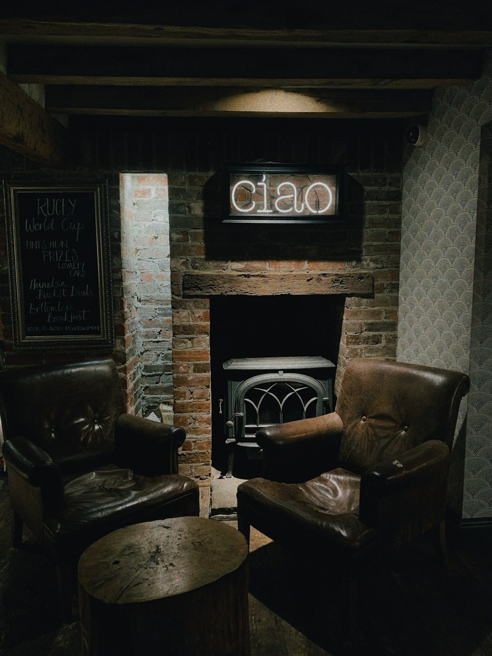 two brown leather armchairs near fireplace