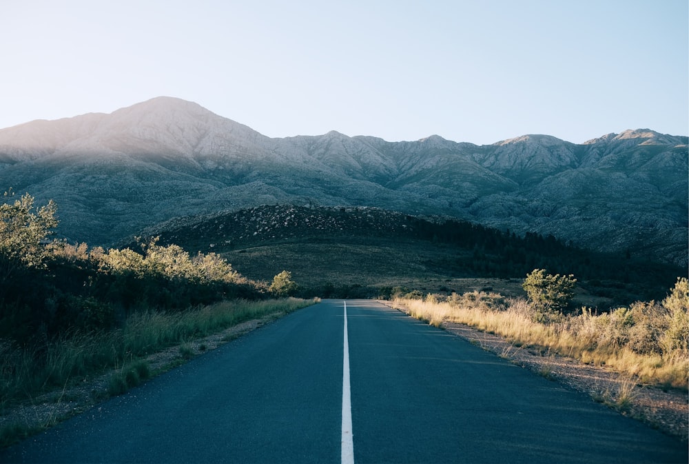 concrete road leading to the mountains