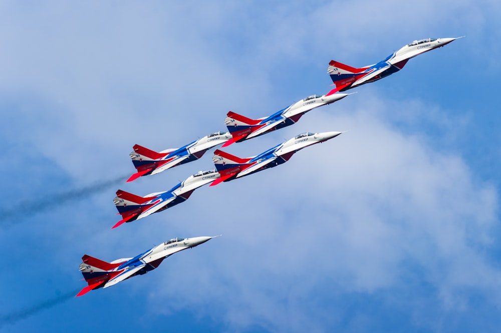 six white, red and blue jet fighter planes