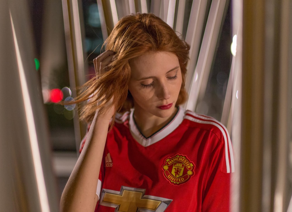 woman wearing red and white V-neck top