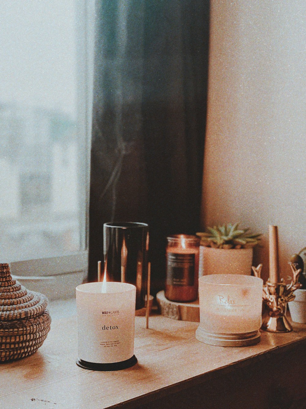 two white candles on a table