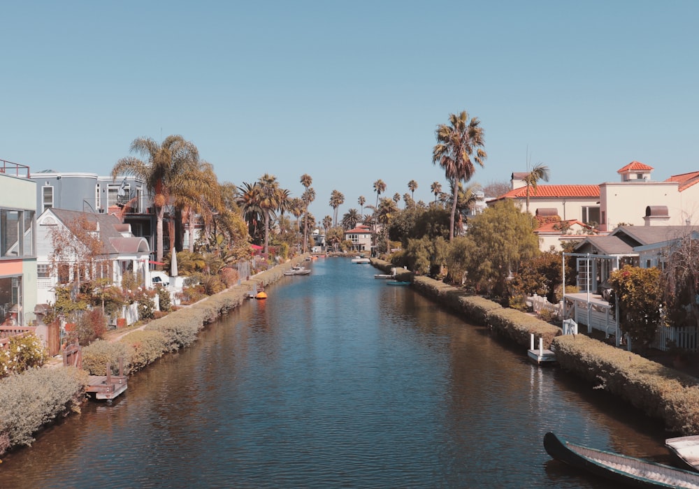 calm body of water in between of houses